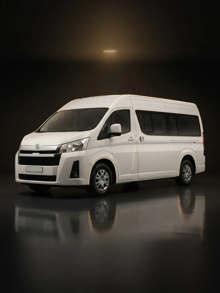 White Toyota Hiace high-roof van in a dark studio