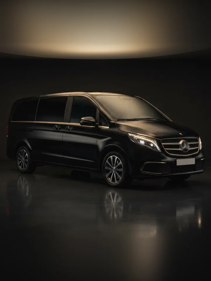 Black Mercedes-Benz V-Class van in a dark studio